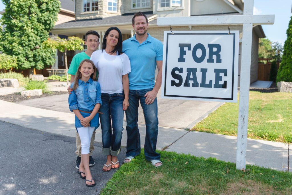 San Bernardino family in front of their home that is for sale